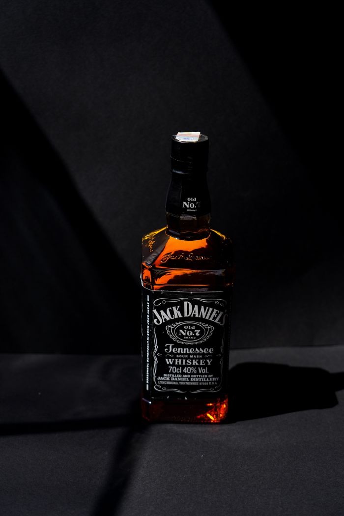 Classic Jack Daniel's Tennessee Whiskey bottle captured with dramatic lighting.